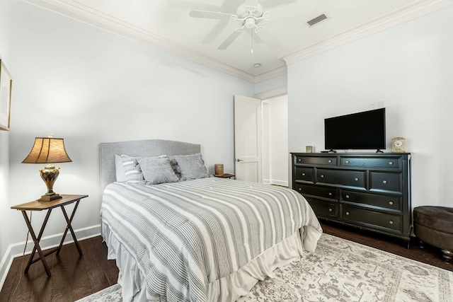 bedroom featuring visible vents, crown molding, baseboards, and wood finished floors