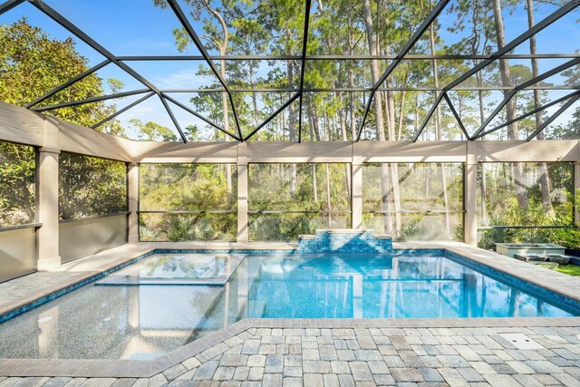 pool featuring a lanai and a patio area