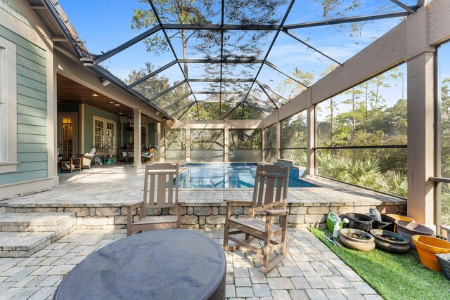 exterior space featuring glass enclosure and an outdoor pool