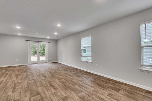 unfurnished room featuring light hardwood / wood-style floors and french doors