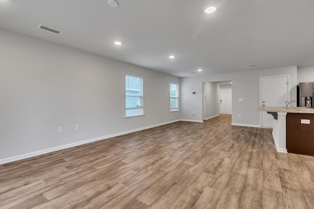 unfurnished living room with light hardwood / wood-style floors