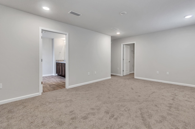 unfurnished room with light colored carpet