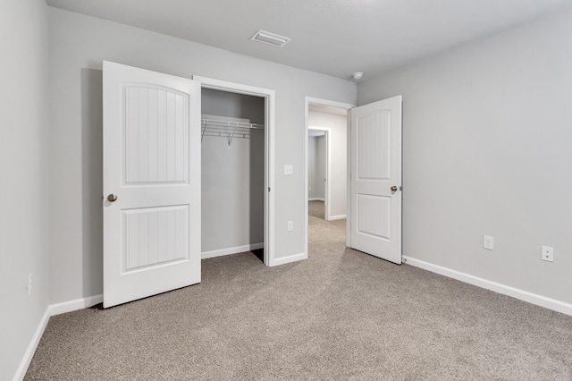 unfurnished bedroom featuring a closet and carpet