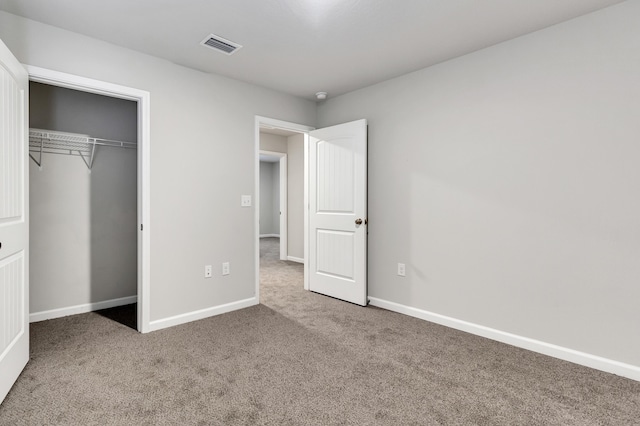 unfurnished bedroom featuring carpet and a closet