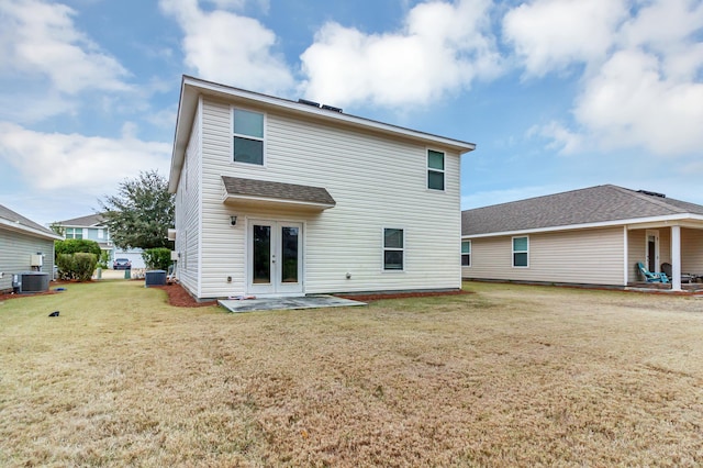 back of house with french doors, central AC unit, a patio area, and a lawn