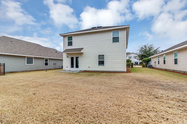 back of house featuring french doors, central AC unit, a patio area, and a lawn