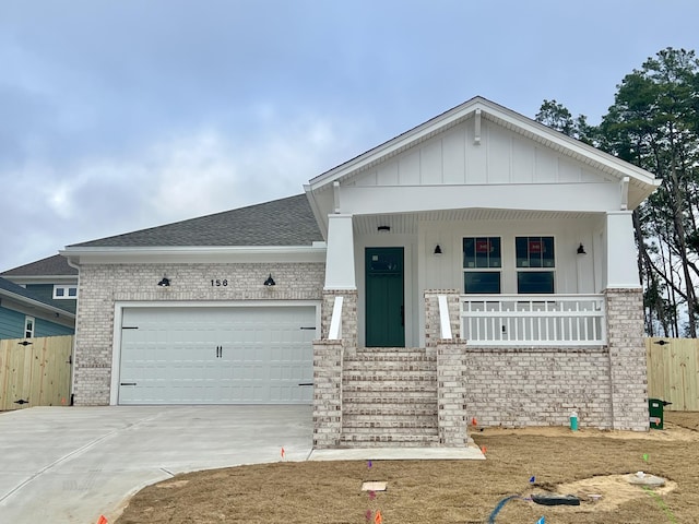 view of front facade with a garage and covered porch