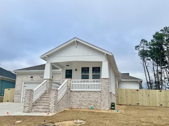 view of front of property featuring a porch and a garage