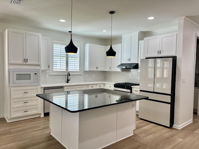 kitchen with white cabinetry, white appliances, a center island, and light hardwood / wood-style flooring