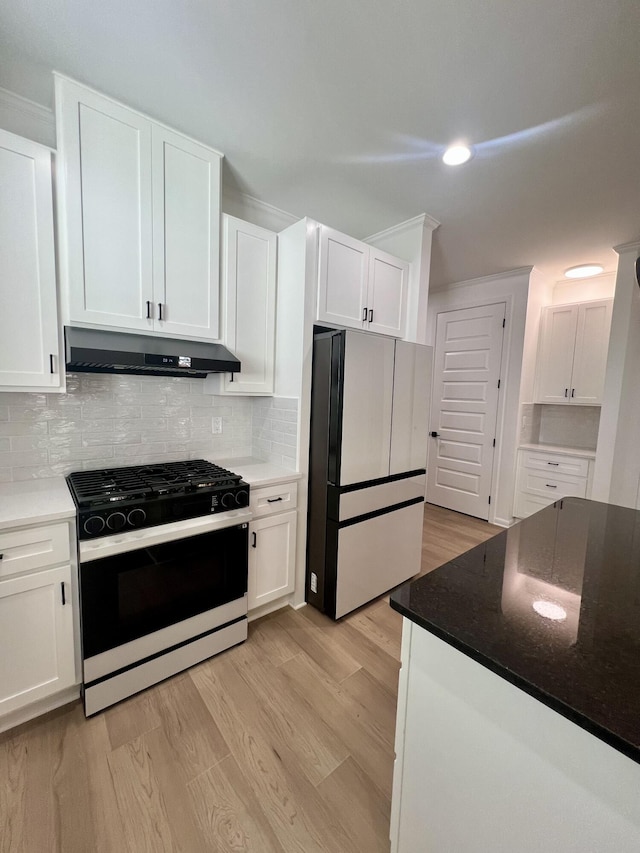 kitchen with white cabinetry, refrigerator, black gas range oven, light hardwood / wood-style floors, and decorative backsplash