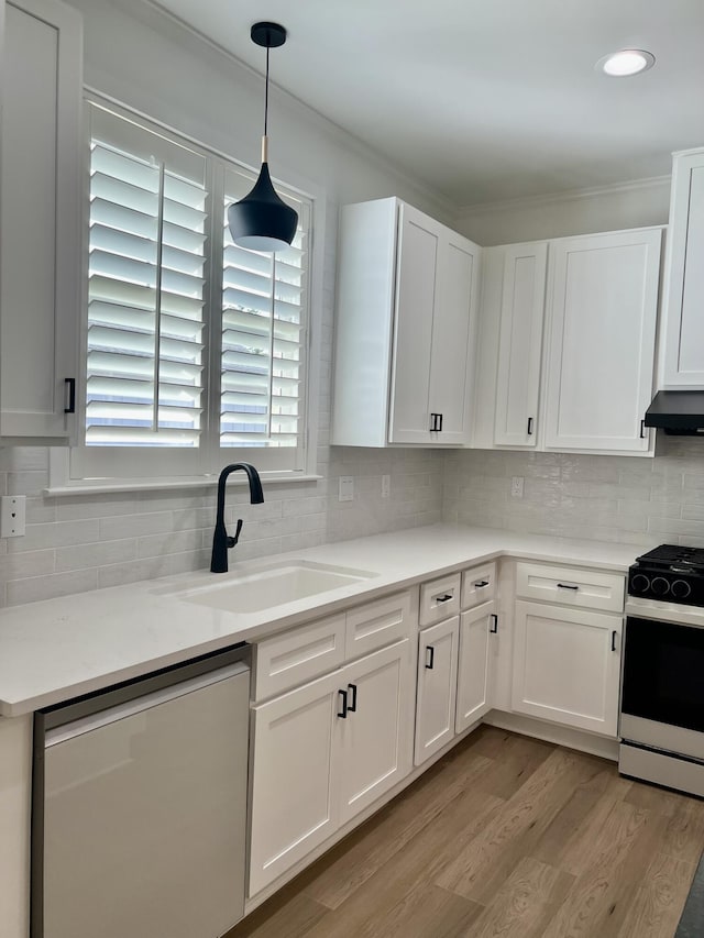 kitchen with gas stove, sink, dishwasher, decorative light fixtures, and white cabinets