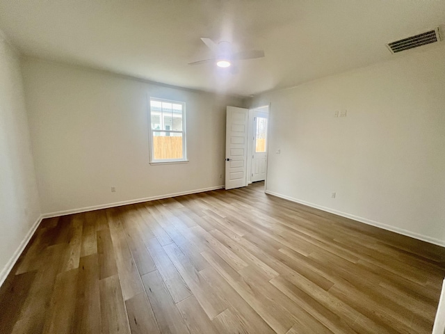 empty room featuring ceiling fan and light hardwood / wood-style flooring