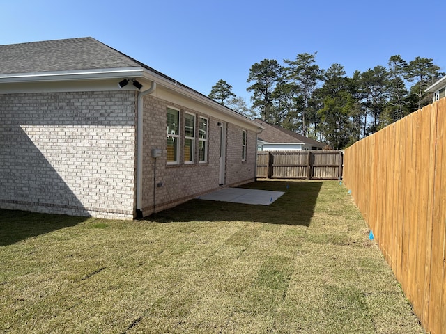 view of side of property with a yard