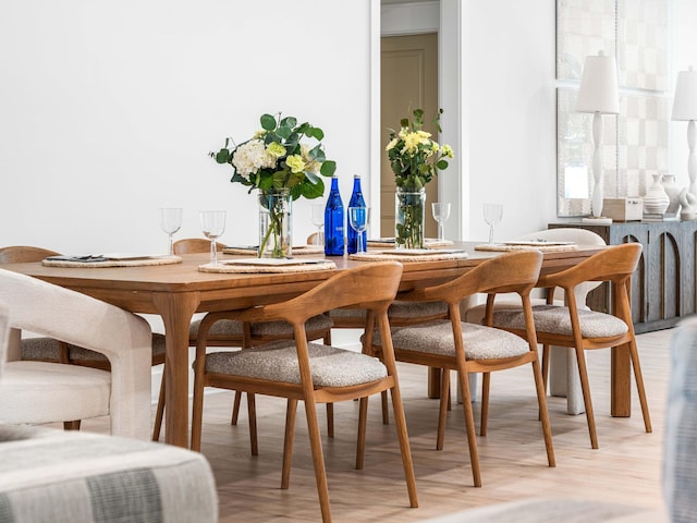 dining space with light hardwood / wood-style floors