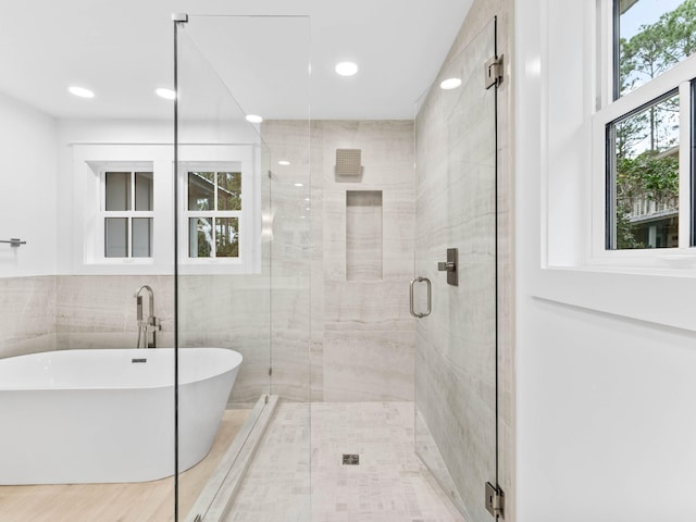 bathroom with separate shower and tub