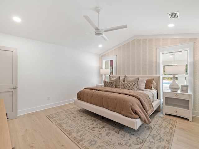 bedroom featuring light wood-type flooring, lofted ceiling, and ceiling fan