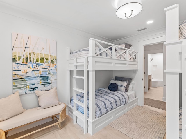 bedroom featuring ornamental molding and wood-type flooring