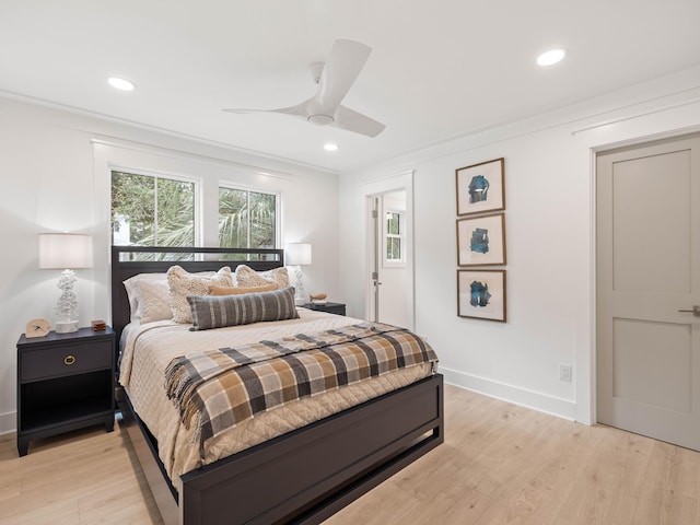 bedroom with multiple windows, ornamental molding, and light hardwood / wood-style floors