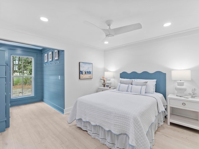 bedroom featuring crown molding, ceiling fan, and light hardwood / wood-style flooring