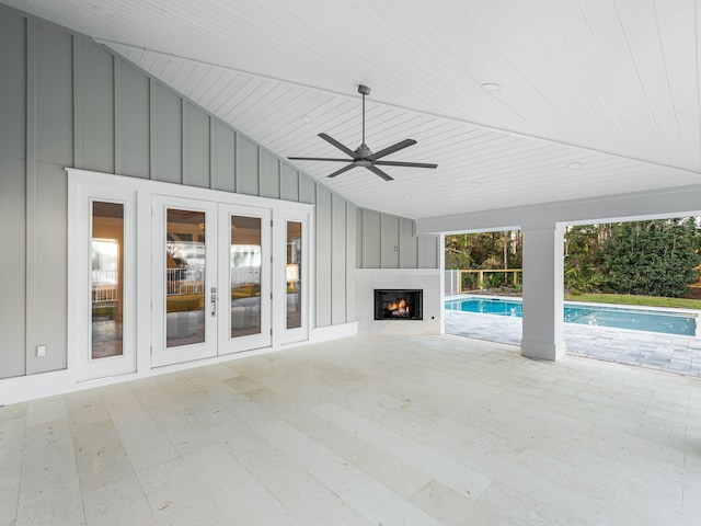 view of patio with ceiling fan and an outdoor fireplace