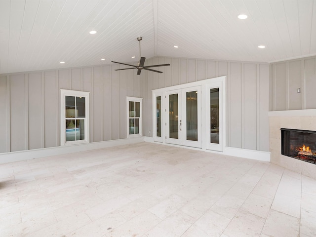 view of patio / terrace featuring ceiling fan, french doors, and an outdoor fireplace