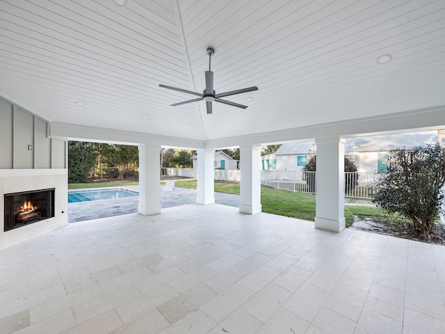 view of patio / terrace featuring ceiling fan and an outdoor fireplace