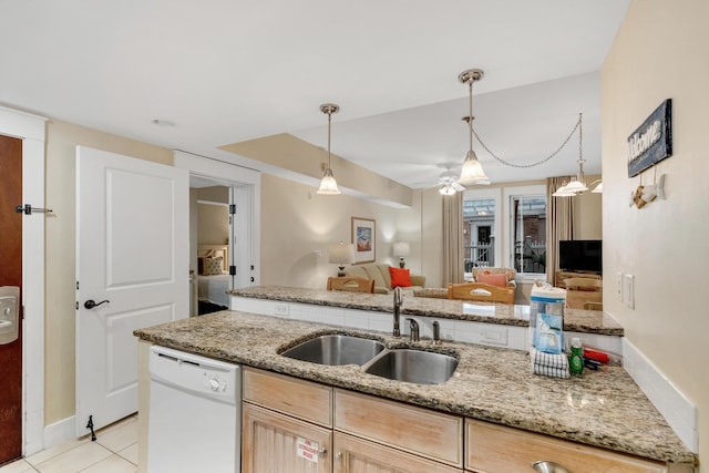 kitchen featuring sink, dishwasher, light stone counters, light tile patterned flooring, and light brown cabinets