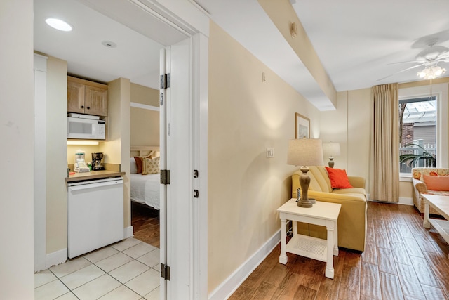 sitting room with ceiling fan and light hardwood / wood-style floors