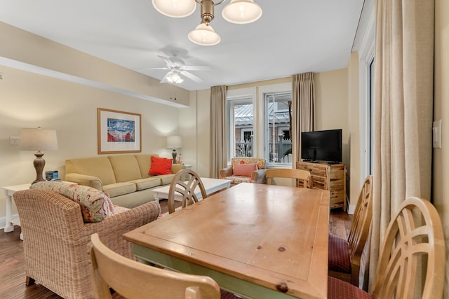 dining area with ceiling fan and dark wood-type flooring