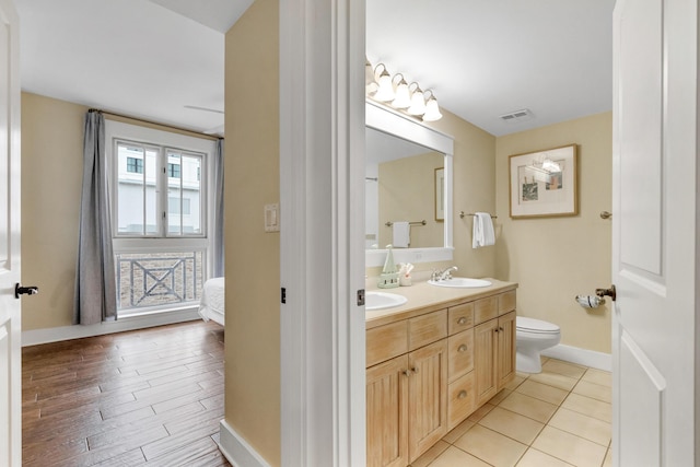 bathroom with tile patterned floors, toilet, and vanity