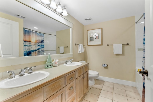 bathroom featuring tile patterned floors, vanity, and toilet