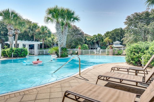 view of swimming pool with a patio and a pergola