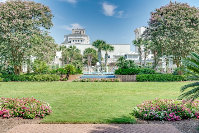 view of property's community with a lawn