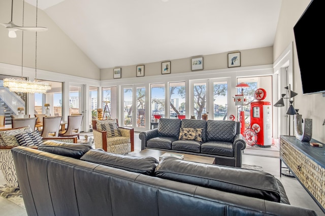 living room with high vaulted ceiling and a notable chandelier