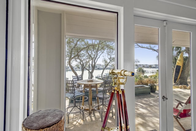 entryway featuring a water view and concrete floors