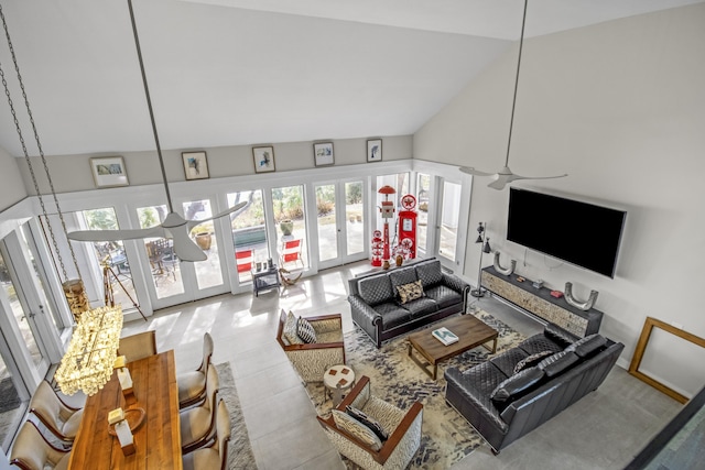 living room with french doors, ceiling fan, and high vaulted ceiling