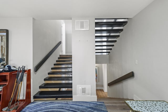 stairway with hardwood / wood-style floors