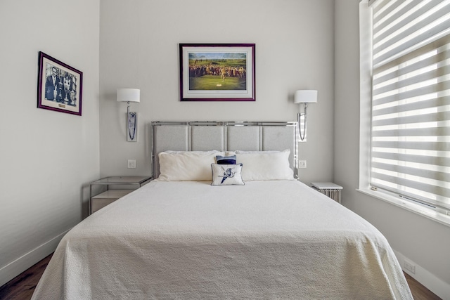 bedroom with dark hardwood / wood-style flooring