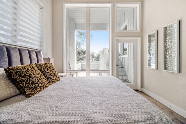 bedroom with hardwood / wood-style flooring and access to exterior