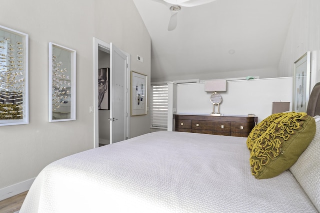 bedroom featuring hardwood / wood-style flooring, ceiling fan, and lofted ceiling