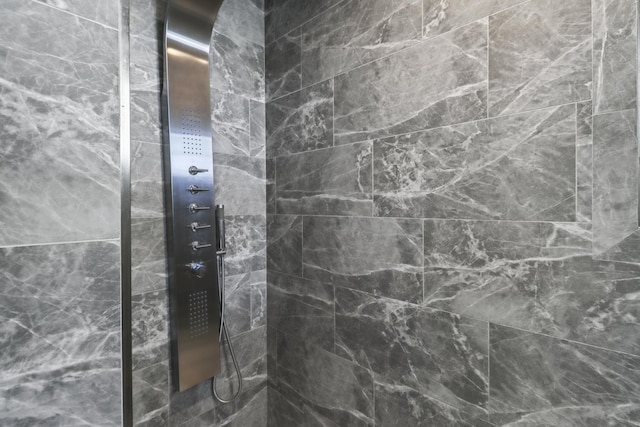 bathroom with tiled shower