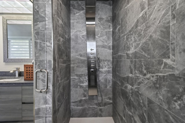 bathroom featuring vanity and a shower with shower door