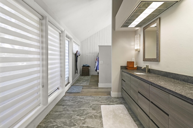 bathroom featuring vanity and vaulted ceiling