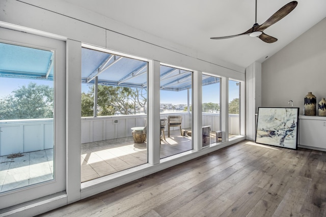 unfurnished sunroom with lofted ceiling and ceiling fan