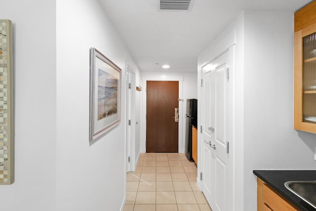 corridor featuring light tile patterned floors