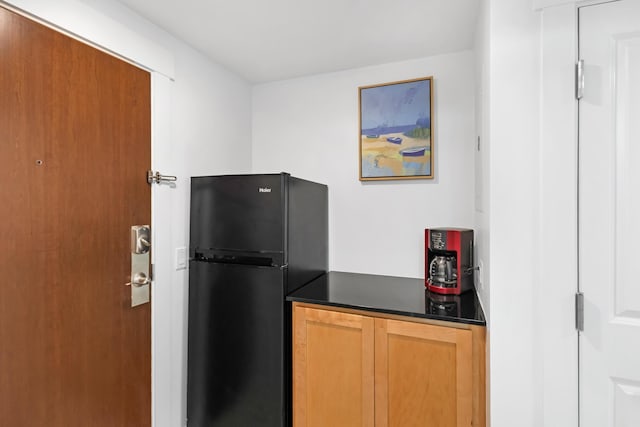 kitchen featuring black fridge