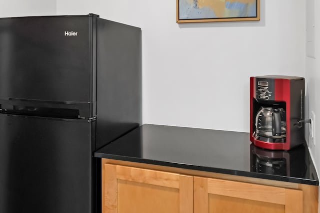 interior space with black fridge