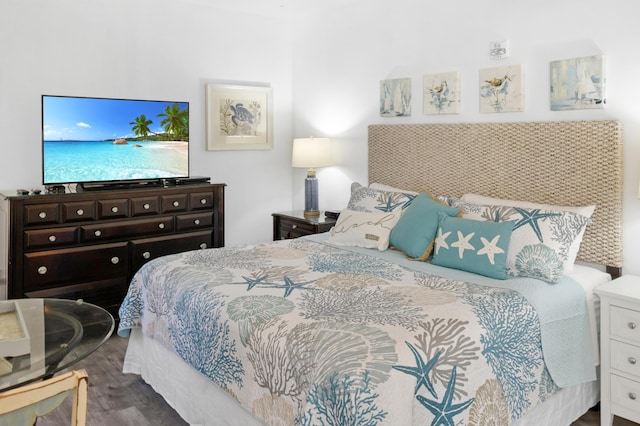 bedroom with dark hardwood / wood-style flooring