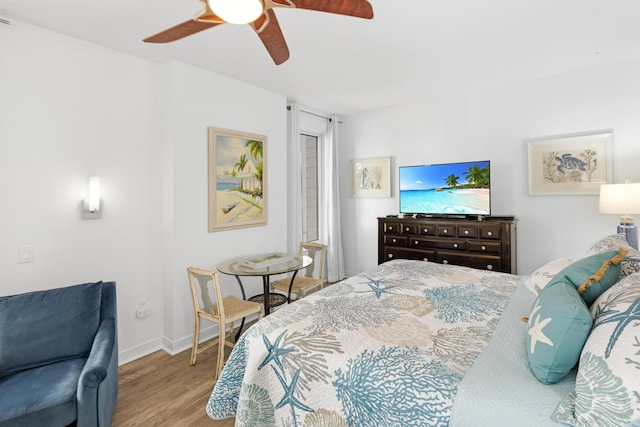 bedroom with light hardwood / wood-style flooring and ceiling fan