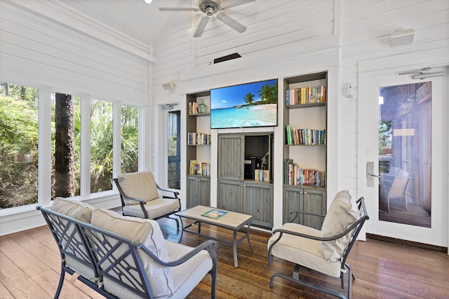 sunroom featuring ceiling fan and vaulted ceiling